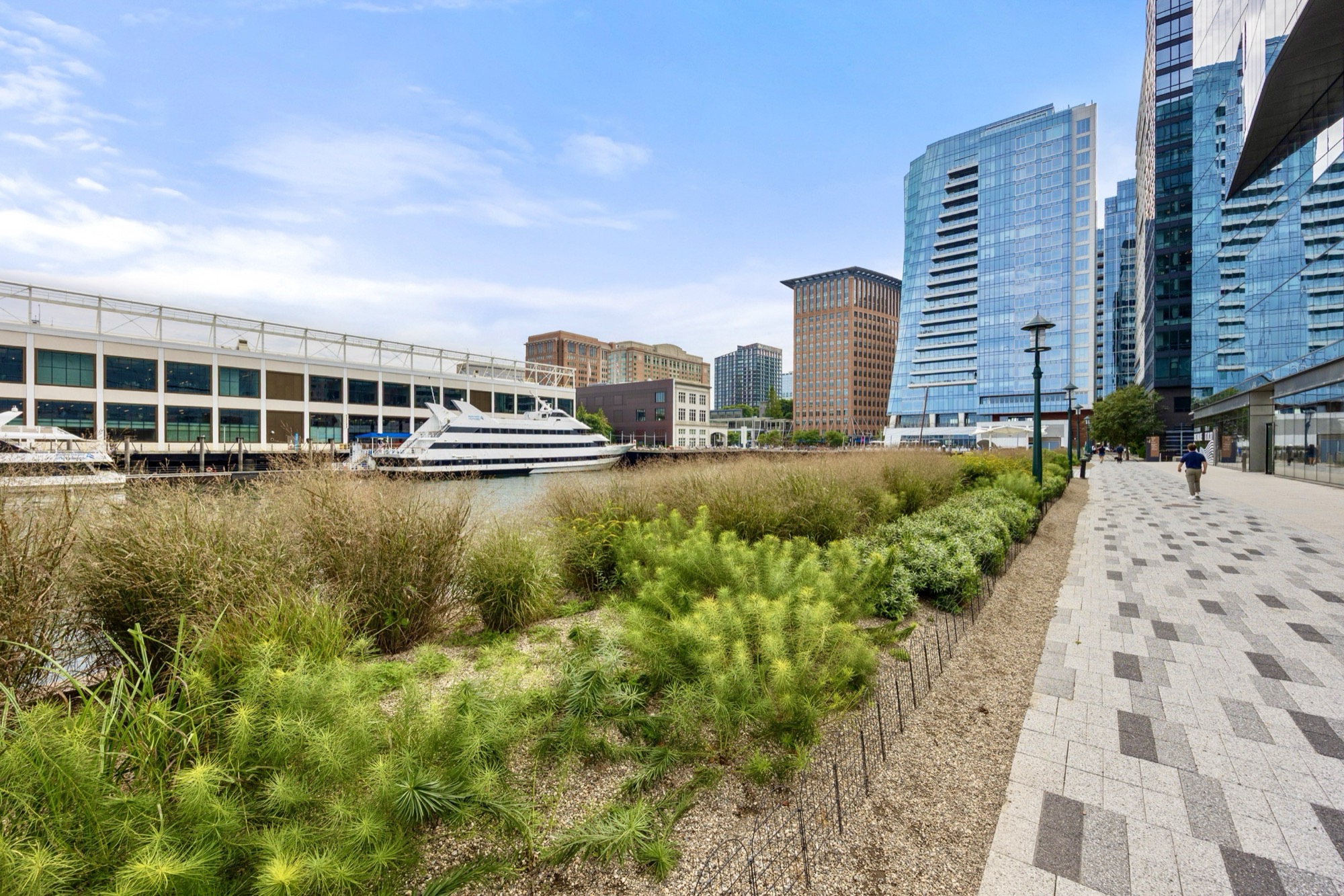 Landscaped Harborwalk beside the Seaport waterfront and skyline