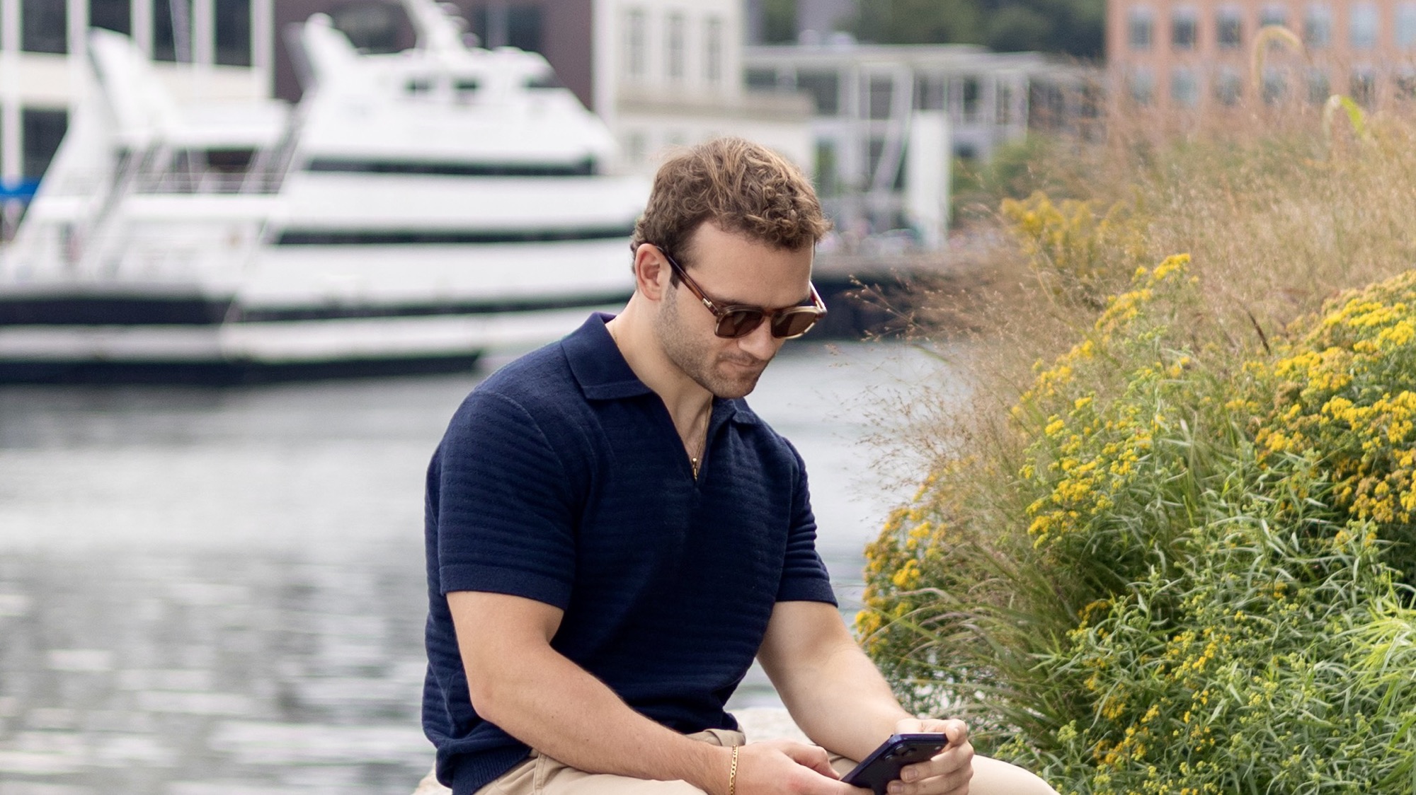 Derek Jesiolowski reviewing market information beside the Seaport harbor